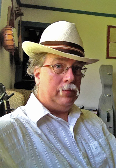Man with glasses and moustache wearing a hat